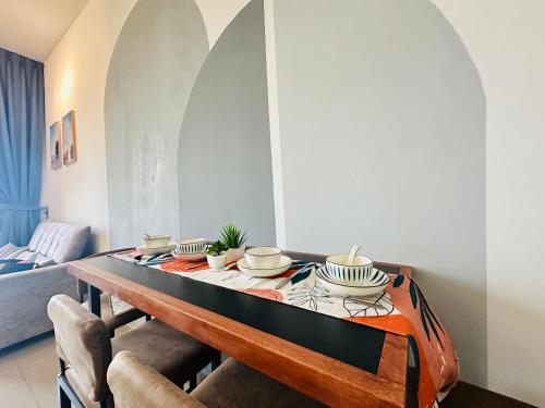 a dining room with a table with dishes on it at 马六甲 Melaka Amber cove residence Jonker Street in Melaka