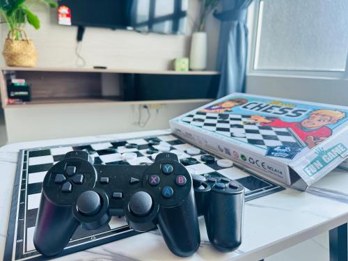a table with two video game controllers and a book at 马六甲 Melaka Amber cove residence Jonker Street in Melaka