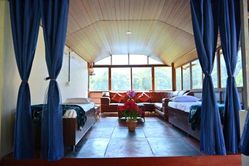 a bedroom with two beds and a couch at Alekadu hill view homestay in Mudigere