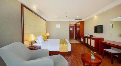 a hotel room with a bed and a television at GreenTree Inn Taiyuan PinGYAng Road Business Hotel in Taiyuan