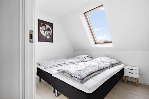 a bed in a room with a window at 6784-Allinge-Nordre-Strandvej-127 in Allinge