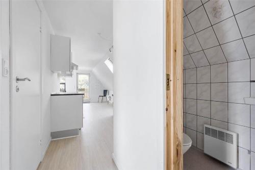 a white kitchen with a sink and a toilet at 6784-Allinge-Nordre-Strandvej-127 in Allinge