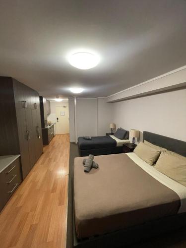 a bedroom with a large bed and a couch at Spinifex Hotel in Derby
