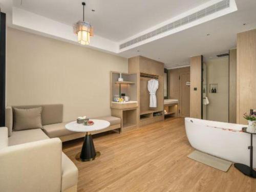 a living room with a couch and a bath tub at Tianrun International Hotel in Dunhuang