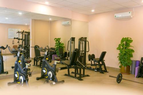 a gym with treadmills and exercise bikes in a room at Le' VIVA Resort Mui Ne in Mui Ne
