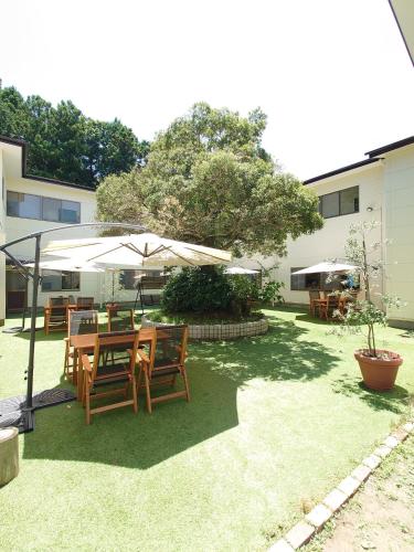 a table and chairs under an umbrella in a yard at Cate no mori - Vacation STAY 21108v in Shime