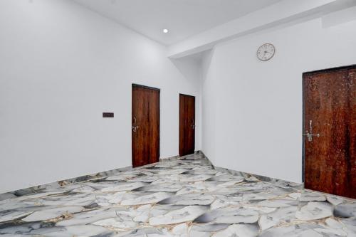 a room with two doors and a marble floor at SPOT ON Hotel Golden Tree in Agra