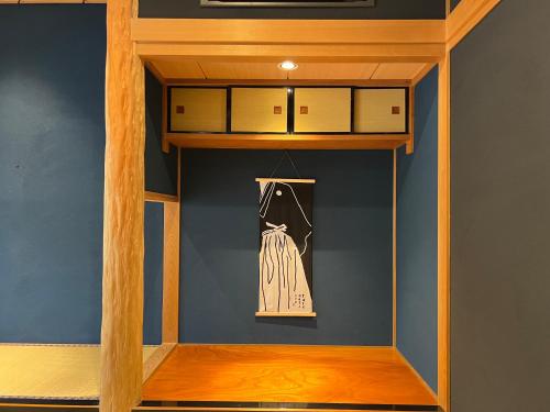 a dressing room with a dress on a shelf at 甚兵衛邸 in Hirado
