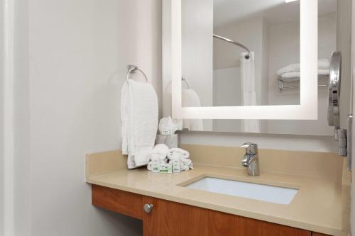 a bathroom with a sink and a mirror at Hawthorn Extended Stay by Wyndham Naples in Naples