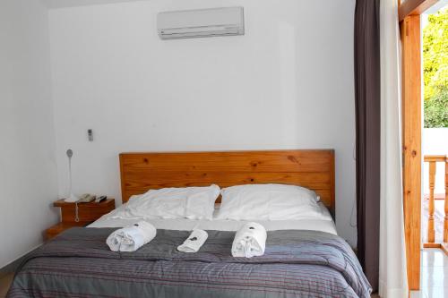 a bedroom with a bed with two slippers on it at Hotel Boutique La Angostura in Ica