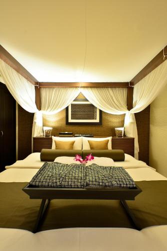 a bedroom with two beds with pink flowers on it at AROMA plus in Tokyo