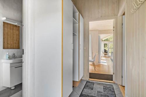 a hallway of a house with a sink and a bathroom at 1563-Aakirkeby-Strandparken-8 in Vester Sømarken