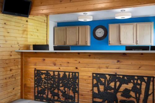 a kitchen with a counter with a clock on the wall at Baymont by Wyndham Duluth Spirit Mountain in Duluth