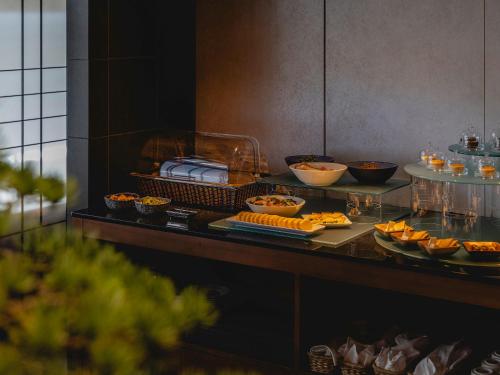 a buffet with food on a counter in a room at Hotel Gracery Kyoto Sanjo in Kyoto