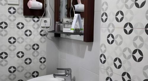 a bathroom with a sink and a shower curtain at GARDEN HOTEL MAJALENGKA in Majalengka