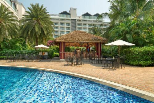 a resort with a pool and a gazebo with tables and chairs at Wyndham Grand Phu Quoc in Phu Quoc