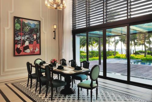 a dining room with a table and chairs at Wyndham Grand Phu Quoc in Phu Quoc