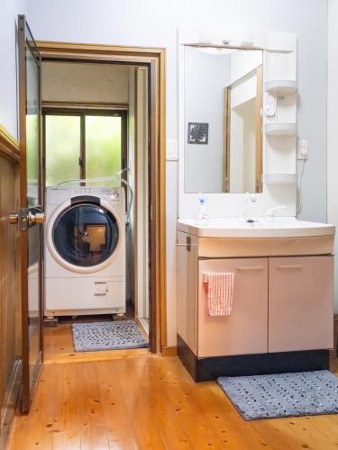 a bathroom with a washing machine and a sink at Gracciaso in Aso