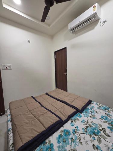 a bedroom with a bed and a air conditioner on the ceiling at Saptagiri elite 104 in Kondapur