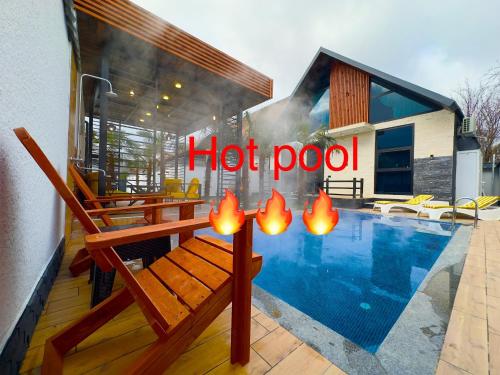 a hot pool with a bench and a hot pool sign at Qafqaz Retro Bungalow HOT POOL in Gabala