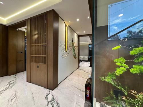 a hallway of a house with a large glass door at Qianheju Hot Spring Private Homestay in Hefei