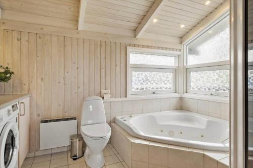 a bathroom with a tub and a toilet and a sink at OH204-Hadsund-Bondes-Bakke-26 in Hadsund