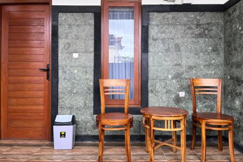 two chairs and a table on a porch at TwoSpaces Living at Bunda Nana Residence, Gianyar in Gianyar