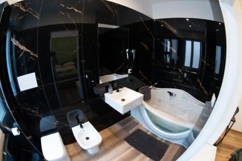 a bathroom with two sinks and a mirror at Altopiano Rooms Suite in Foggia