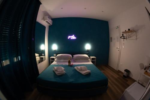 a bedroom with a bed with towels on it at Altopiano Rooms Suite in Foggia