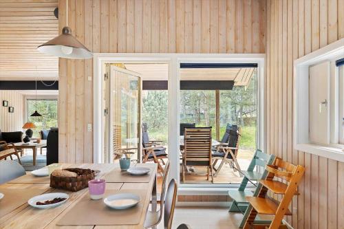 a dining room with a table and chairs and a window at 2726-Nexo-Fjaelstaunijn-14 in Vester Sømarken