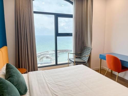 a hotel room with a bed and a view of the ocean at Sunset town Phú Quốc in Phu Quoc