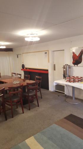 a classroom with tables and chairs and a white board at Walton Park Motor Lodge in Warkworth