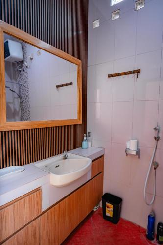 a bathroom with a sink and a mirror at INEZ Homestay in Timuran