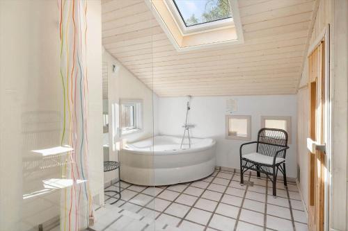 a bathroom with a tub and a chair in it at 2722-Nexo-Jaegerstien-6 in Neksø