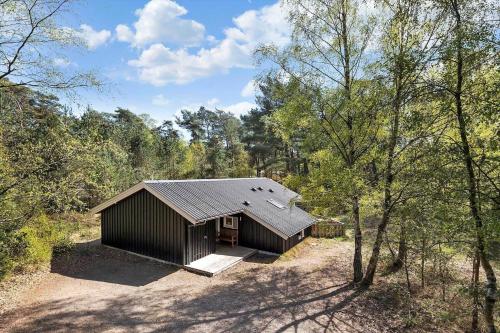 a small building in the middle of a forest at 2722-Nexo-Jaegerstien-6 in Neksø