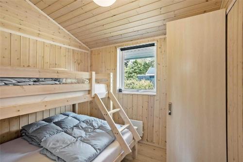 a small bedroom with a bunk bed and a window at OH287-Hadsund-Haslevgarde-Eng-1 in Hadsund
