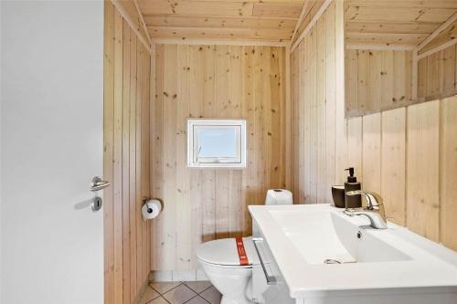 a bathroom with a white sink and a toilet at OH287-Hadsund-Haslevgarde-Eng-1 in Hadsund