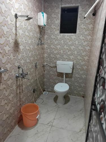 a small bathroom with a toilet and a window at sai villa lodging and bording in Virār