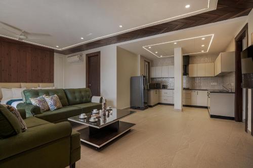 a living room with a couch and a table at SaffronStays Library Enclave Maharajah Suite - 1-BHK Luxury Apt with Valley View, Mall Road Mussoorie in Mussoorie
