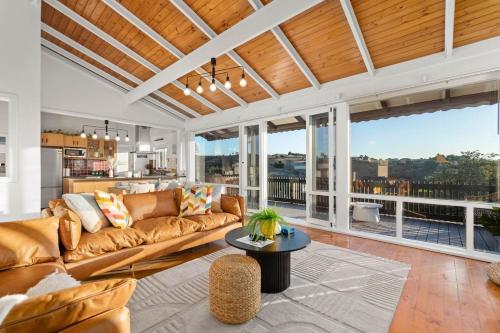 a living room with a couch and a table at Captivating Vista Retreat Exquisite Holiday Haven in Bedford Park