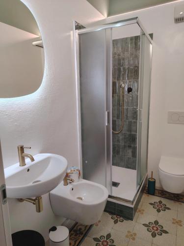 a white bathroom with a sink and a shower at Vlll PORTICO in Bologna