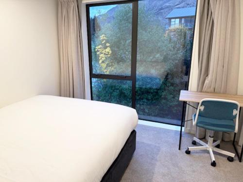 Postel nebo postele na pokoji v ubytování Swiss-Belresort and Villas Coronet Peak