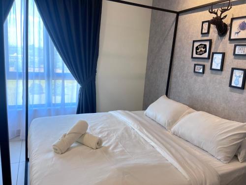 a bed with a stuffed animal laying on it at Tamarind Square Edusphere 3min 6pax dualkey in Cyberjaya