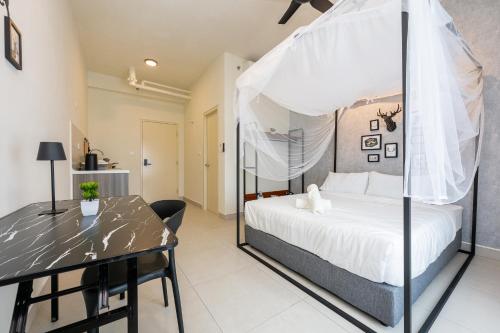 a bedroom with a bed and a dining table at Tamarind Square Edusphere 3min 6pax dualkey in Cyberjaya