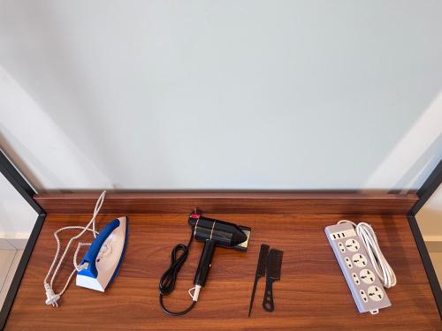 a table with a remote control and a controller at Tamarind Square Edusphere 3min 6pax dualkey in Cyberjaya