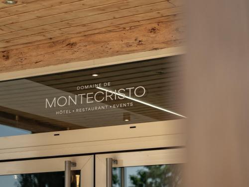 a sign on the front of a building at Logis Hôtel-Restaurant Domaine de Montecristo in Bourguignons