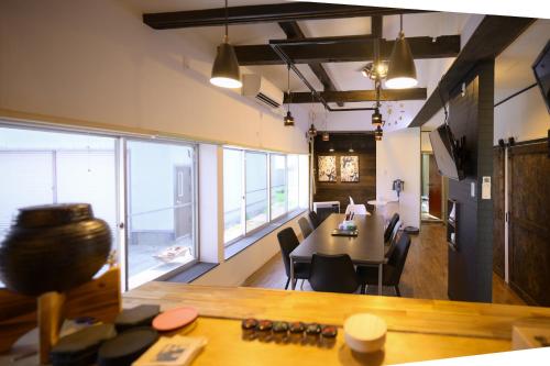 a dining room with a table and a large window at グッドタイム細越 in Aomori