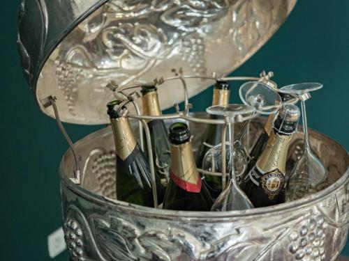 a group of wine bottles in a metal bucket at Logis Hôtel-Restaurant Domaine de Montecristo in Bourguignons