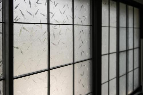 a glass window with a bunch of birds on it at グッドタイム細越 in Aomori