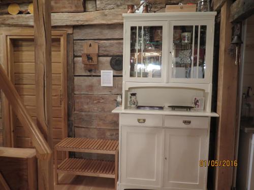 a kitchen with a white cabinet and a staircase at Apartments Montana in Fužine